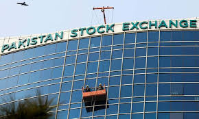 Workers clean a glass facade of the Pakistan Stock Exchange (PSX) building in Islamabad.